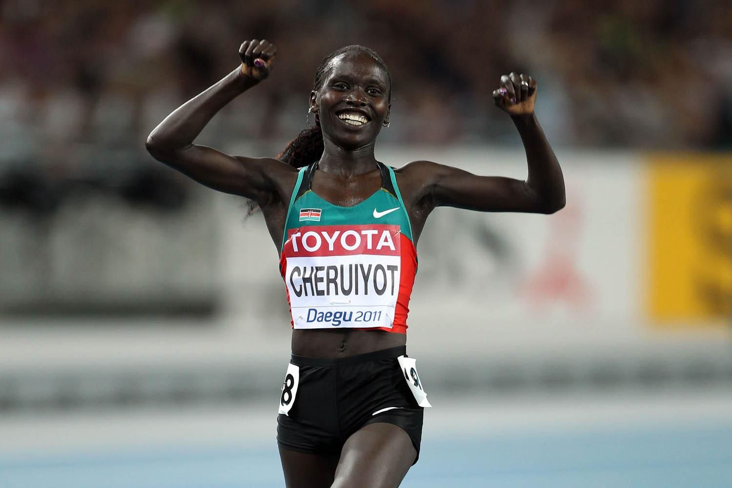 Vivian Jepkemoi Cheruiyot of Kenya celebrates as she crosses the finish line to win the women's 10,000 metres final during day one 