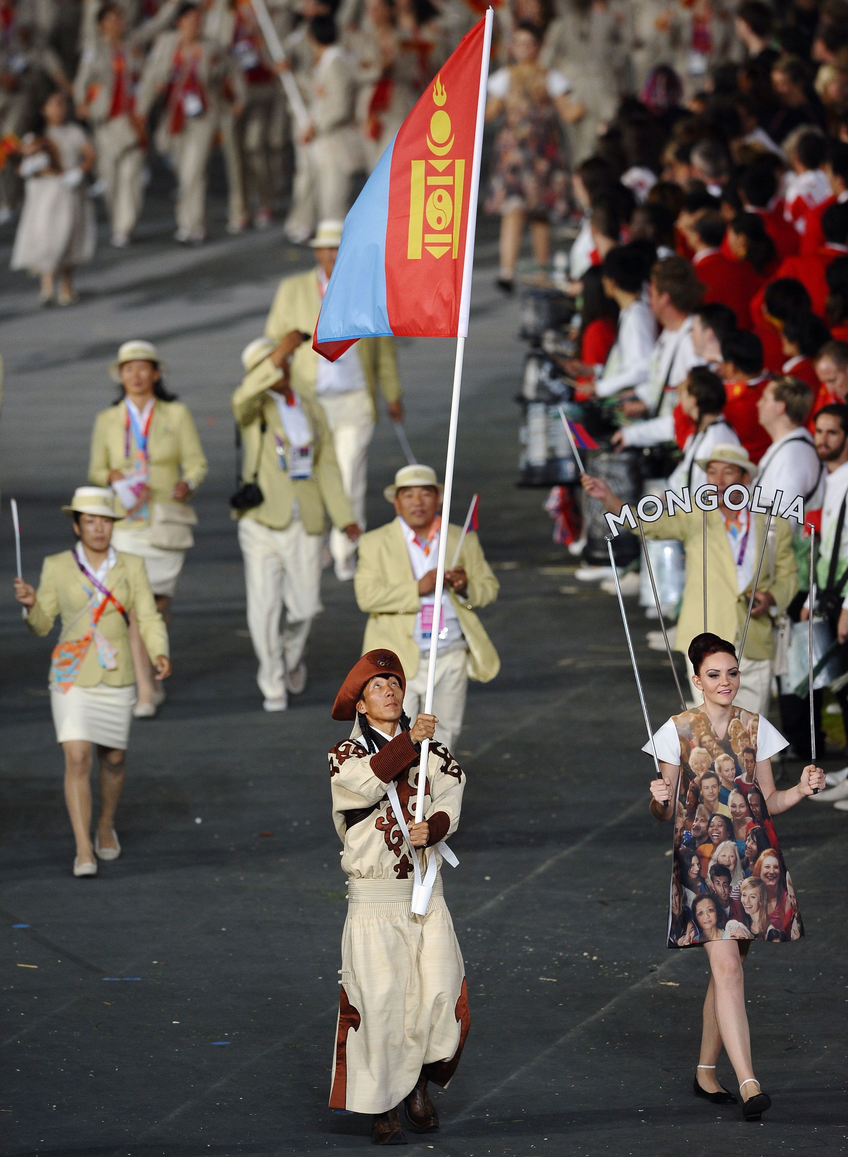 Mongolian Ser-Od Bat-Ochir carries his country's flag during the opening ceremony of the London 2012 Olympics.