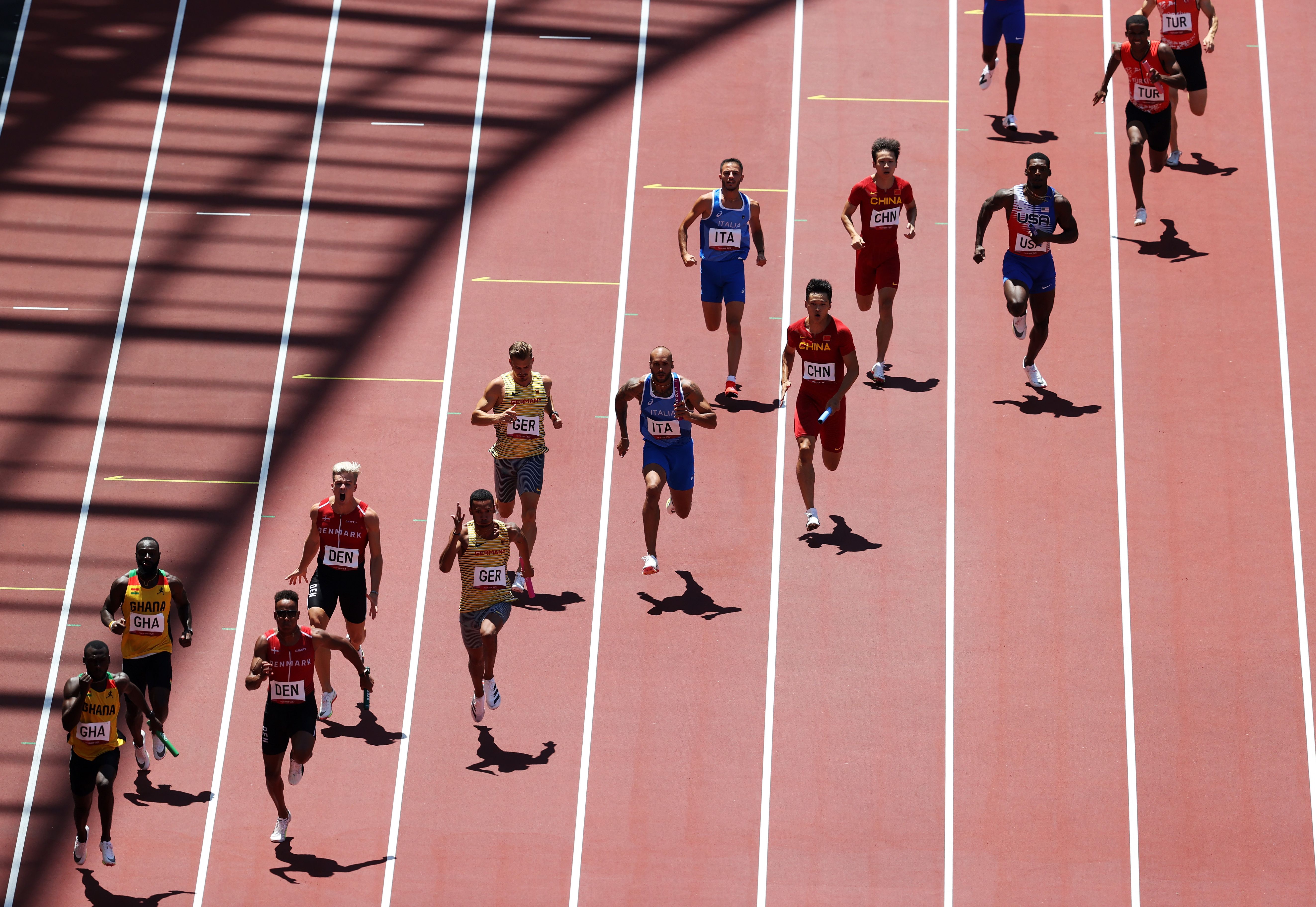 Marcell Jacobs (centre) in the 4x100m heats at the Tokyo Olympic Games