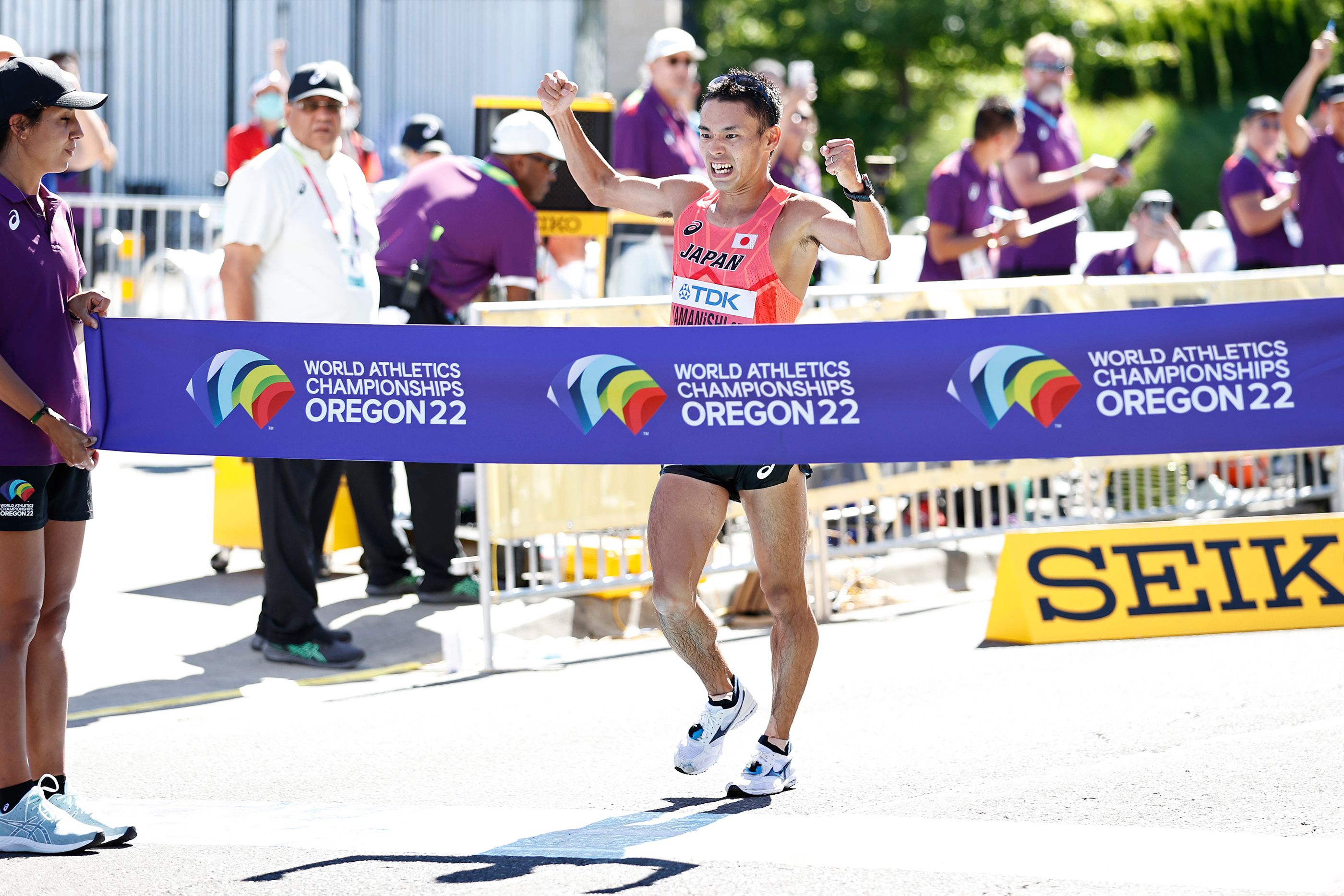 Toshikazu Yamanishi celebrates his 20km race walk win in Oregon
