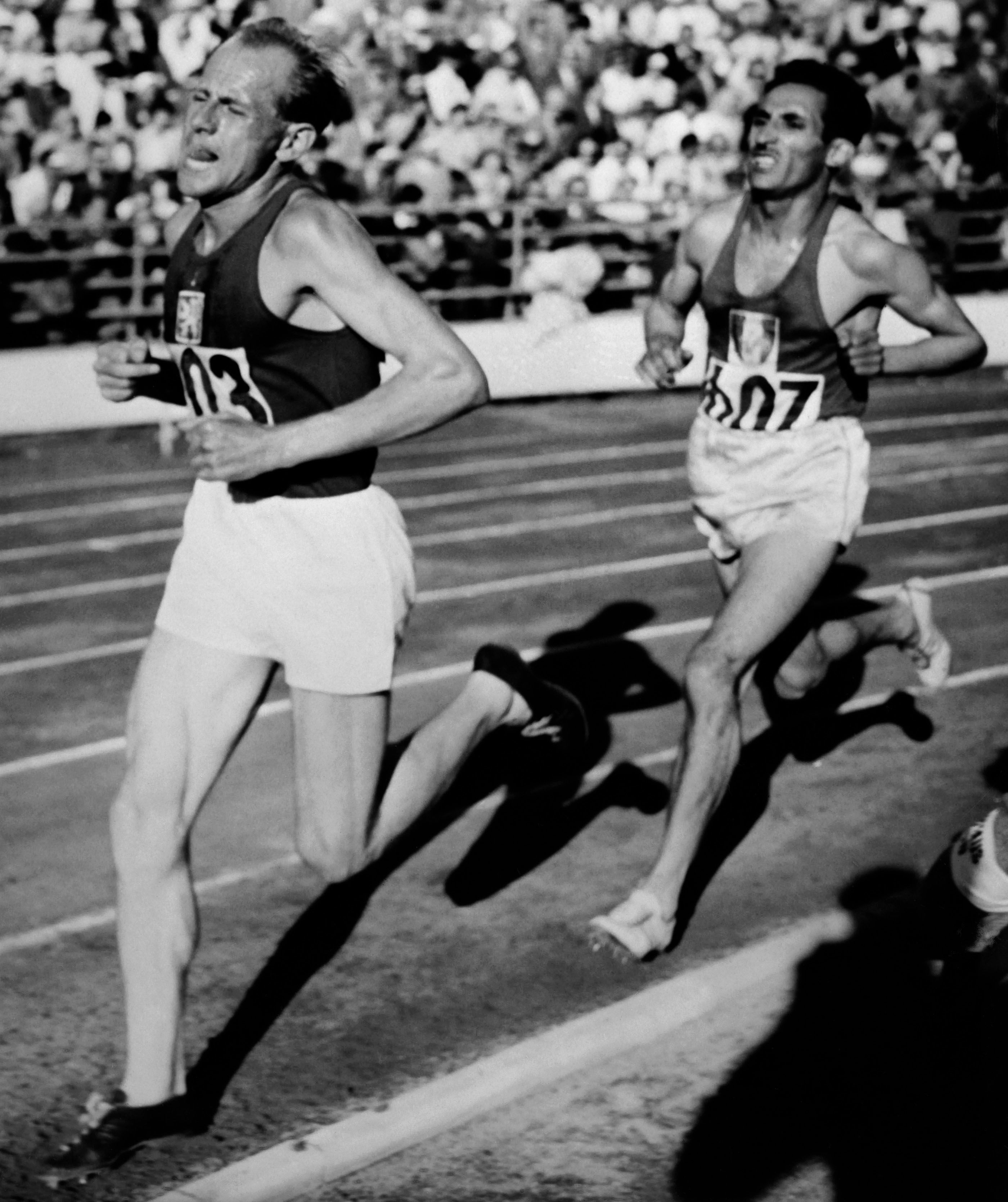 Emil Zatopek leads in front of Alain Mimoun during the Olympic 5000m in Helsinki 1952