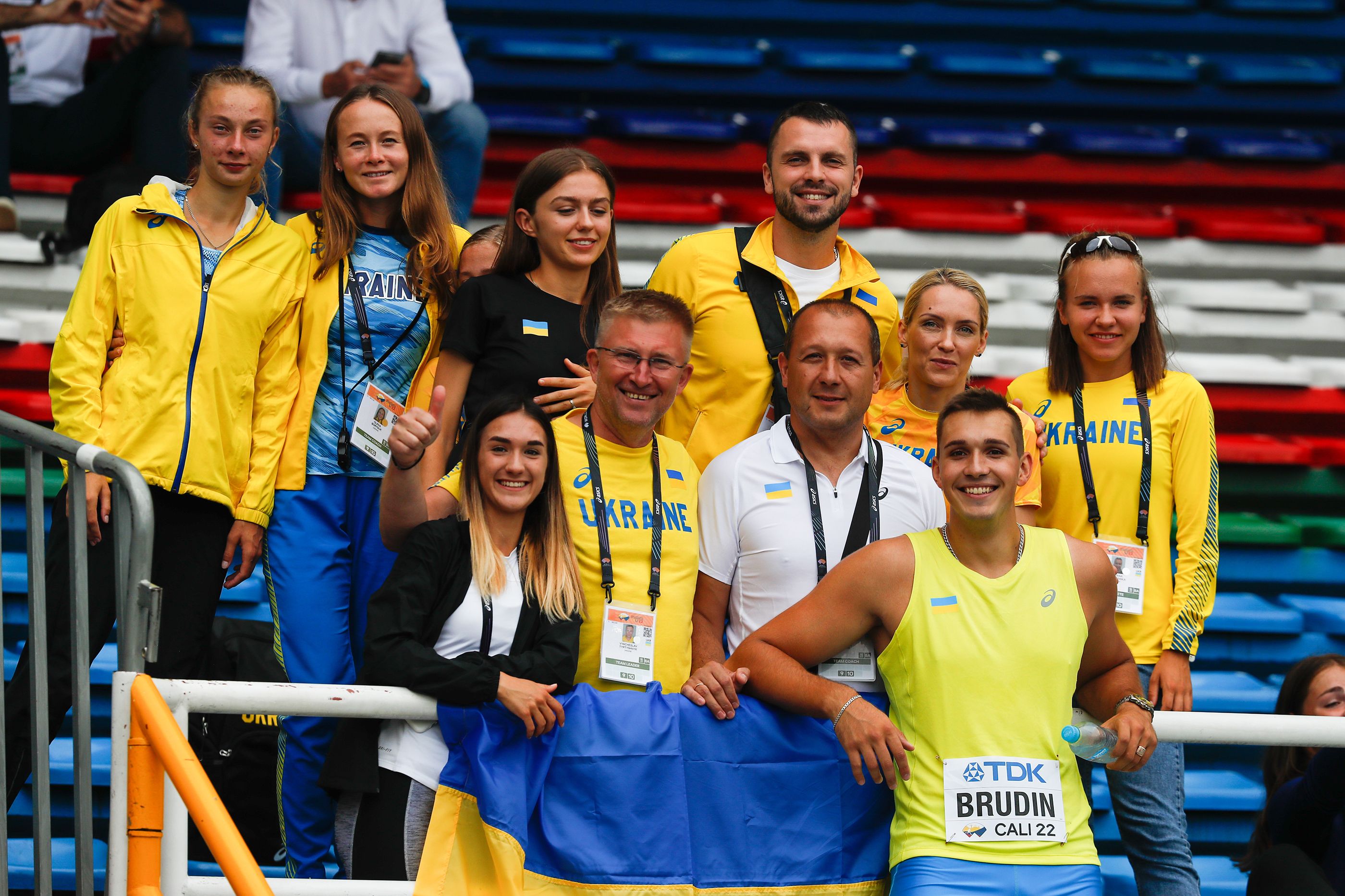 Mykhailo Brudin celebrates his qualification for the discus final with some of the Ukraine team