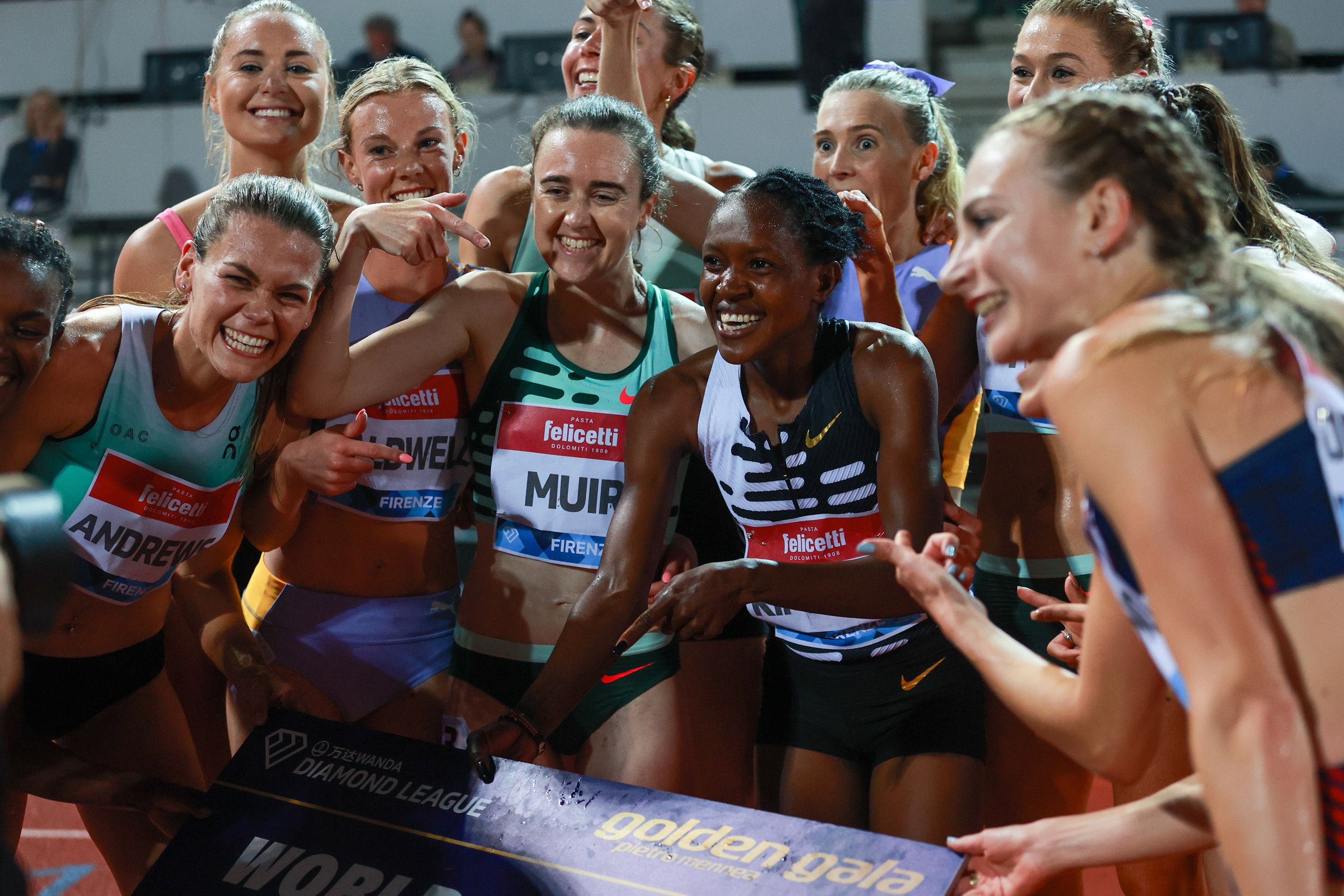 Faith Kipyegon celebrates her world record with the 1500m field in Florence