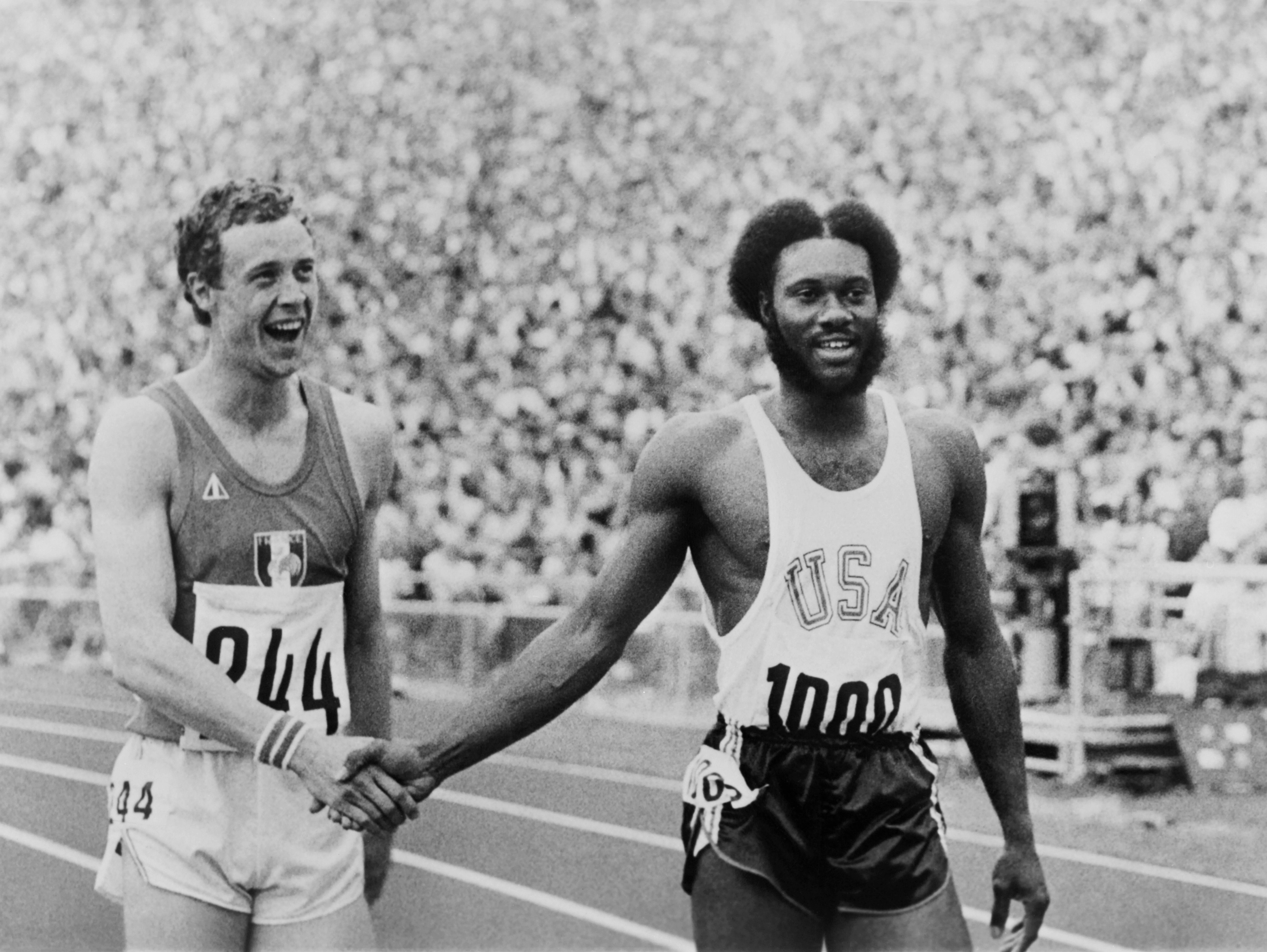 Silver medallist Guy Drut and winner Rod Milburn shake hands after the 110m hurdles at the Munich 1972 Olympic Games