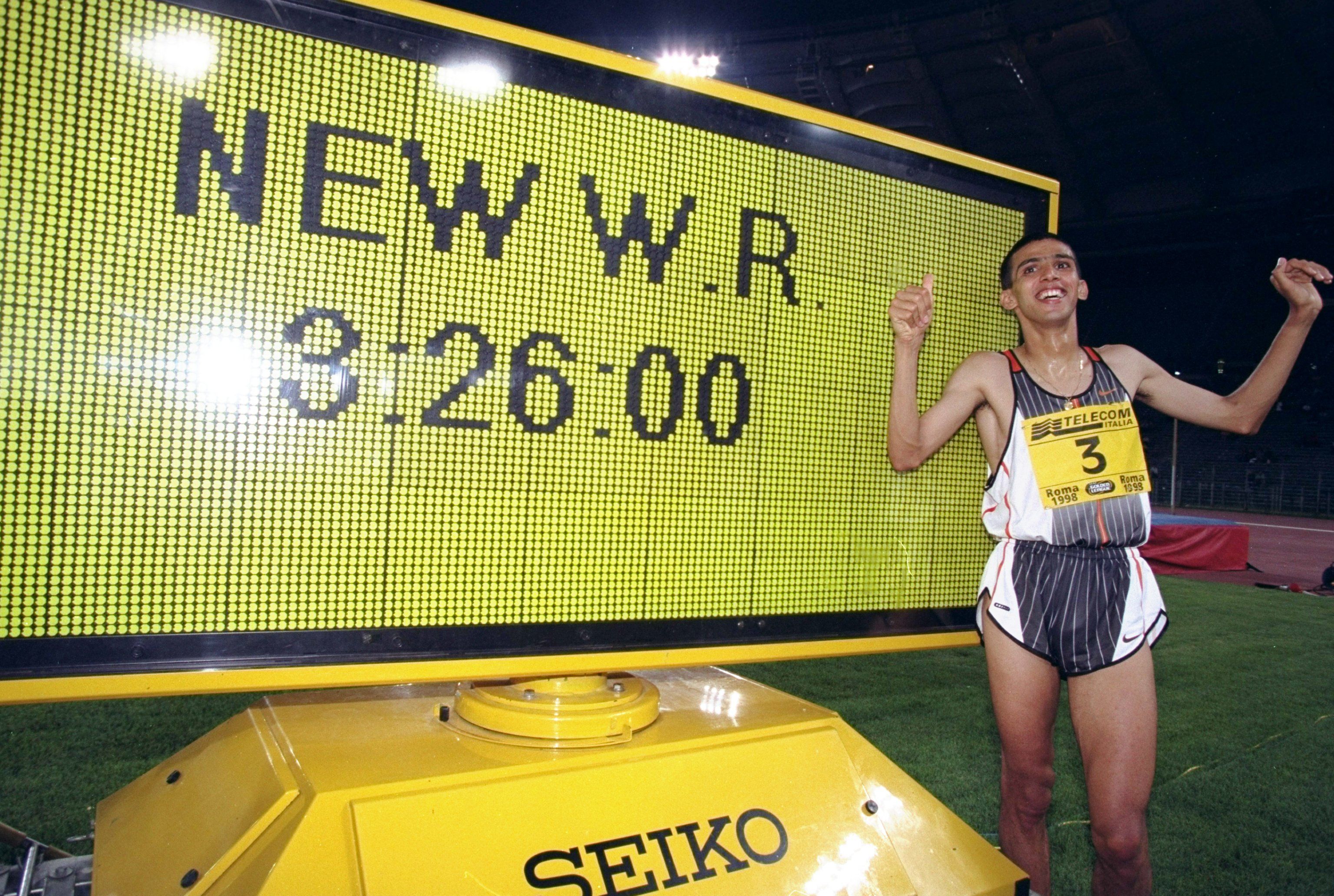 Hicham El Guerrouj celebrates next to his world 1500m record figures in Rome in 1998