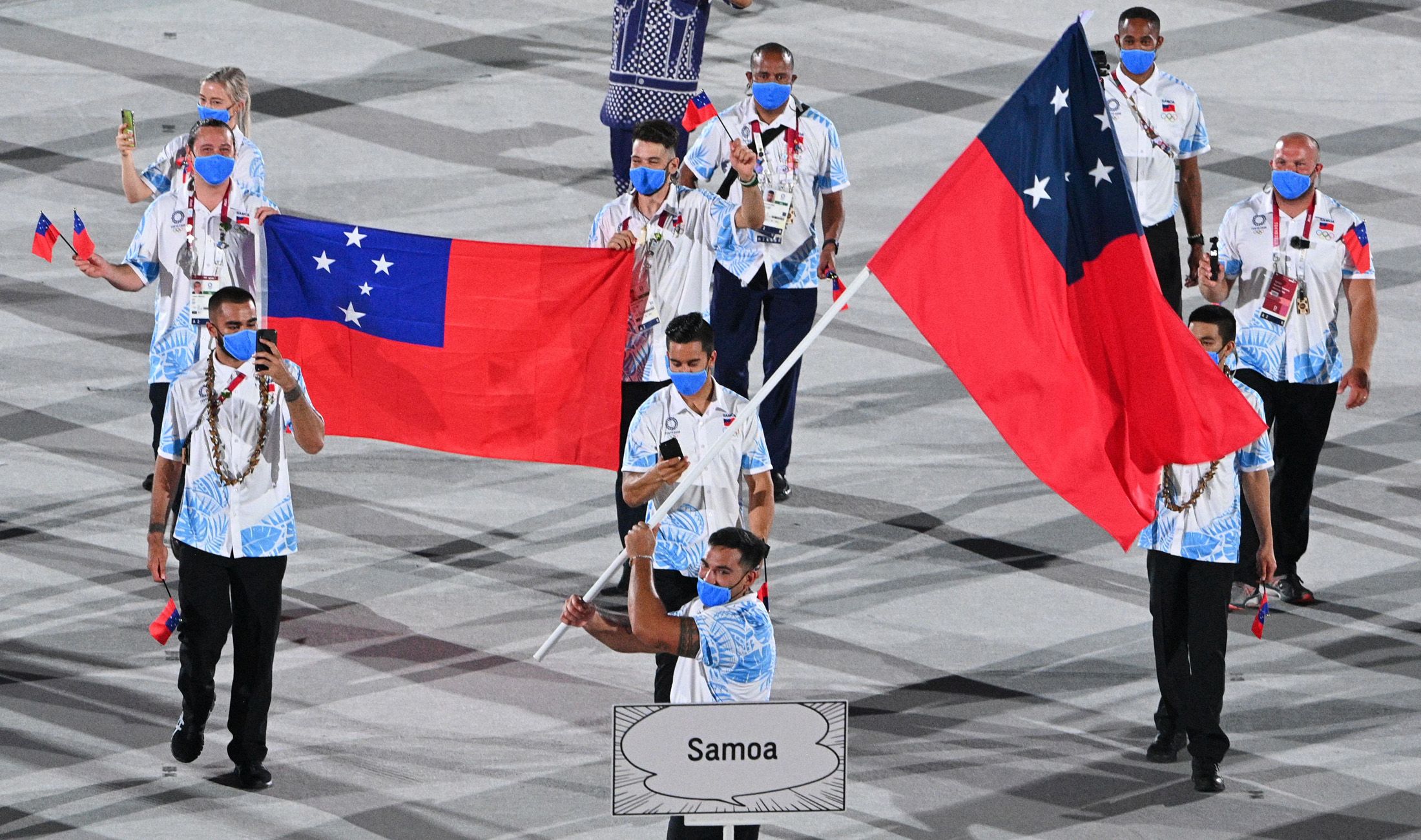 Alex Rose carries Samoa's flag at the Tokyo Olympics opening ceremony