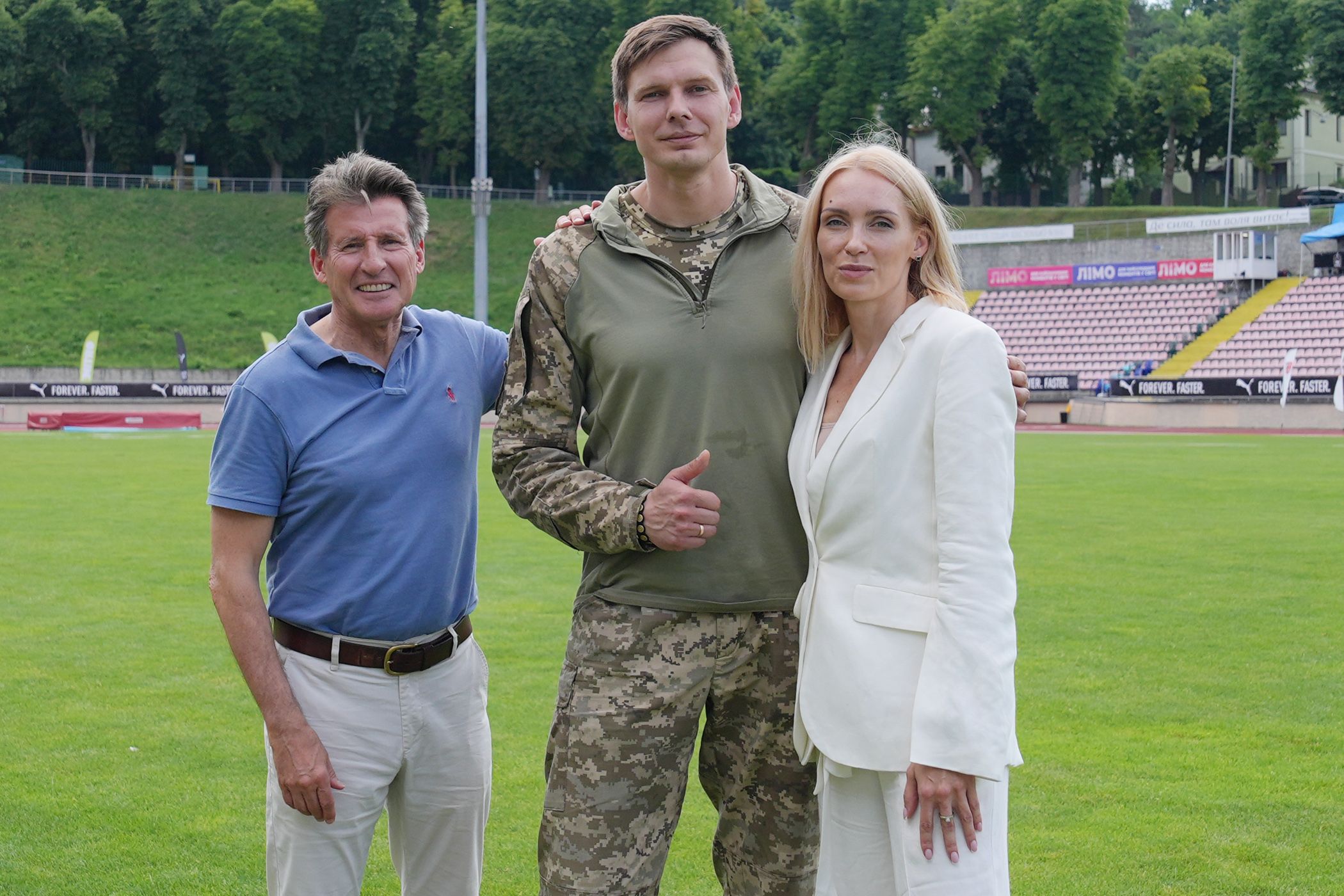 World Athletics President Sebastian Coe with former high jumper Dmytro Demyanyuk and Olha Saladukha