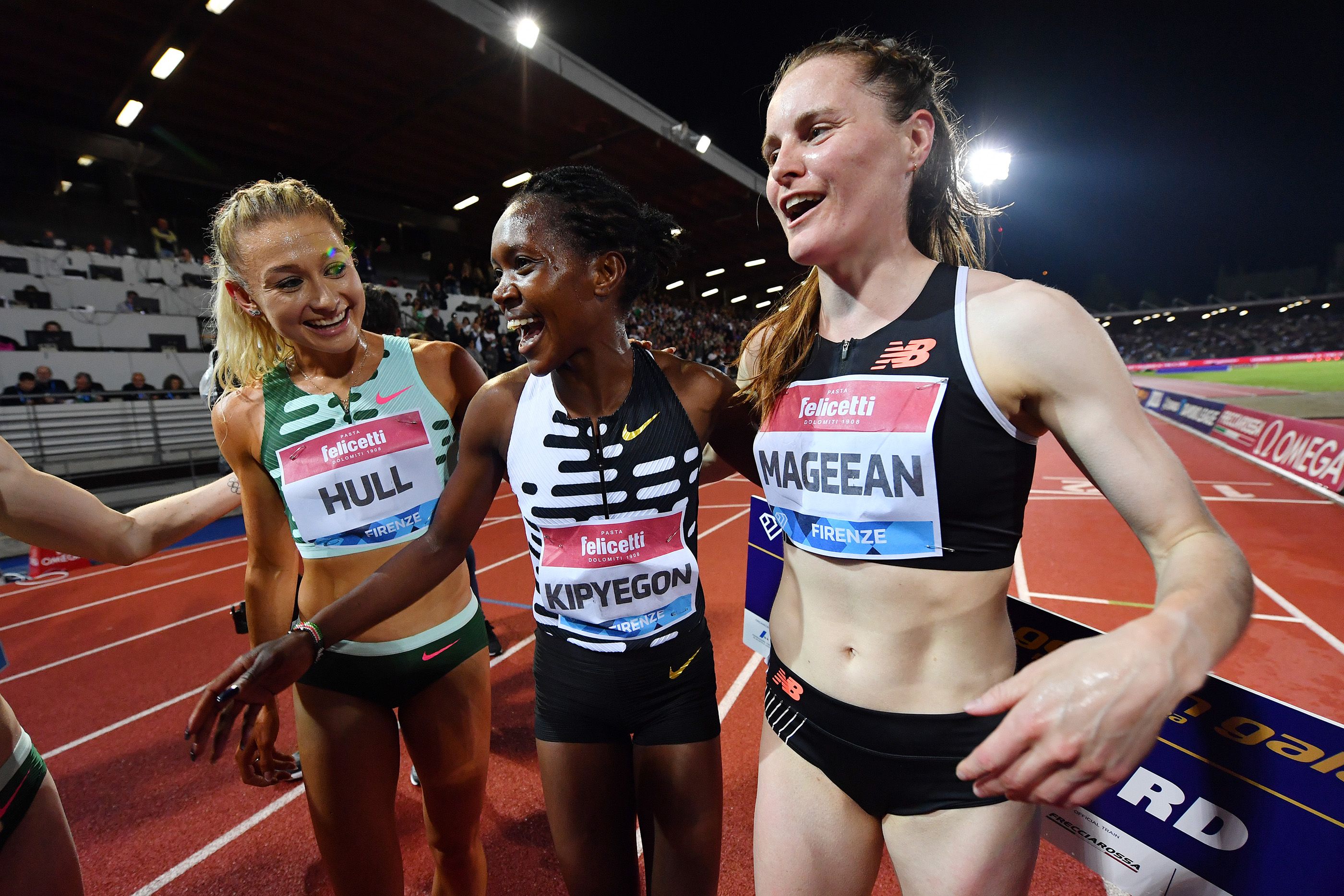 Jessica Hull celebrates with Faith Kipyegon after Kipyegon's world 1500m record in Florence