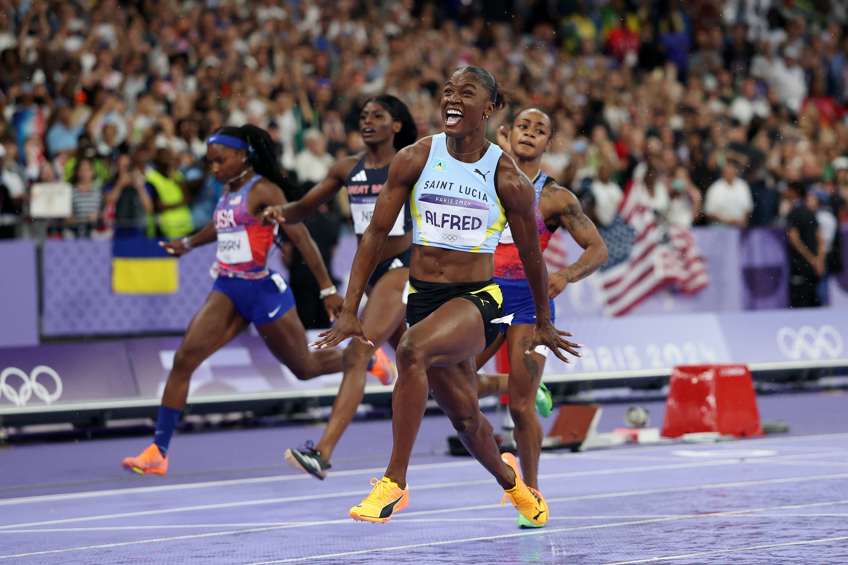 Julien Alfred celebrates her 100m win at the Paris 2024 Olympic Games