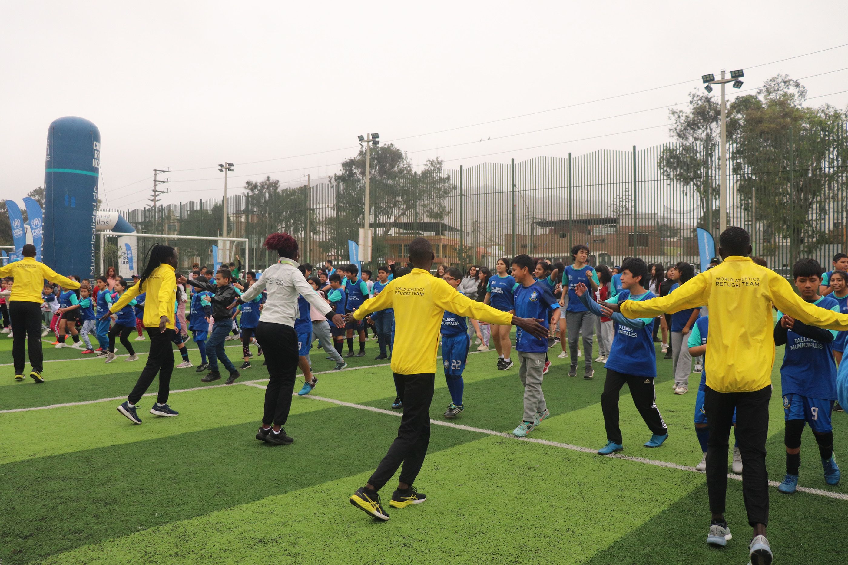 The Athlete Refugee Team leads a warm-up session at the Complejo Deportivo N°1 in Chorrillos