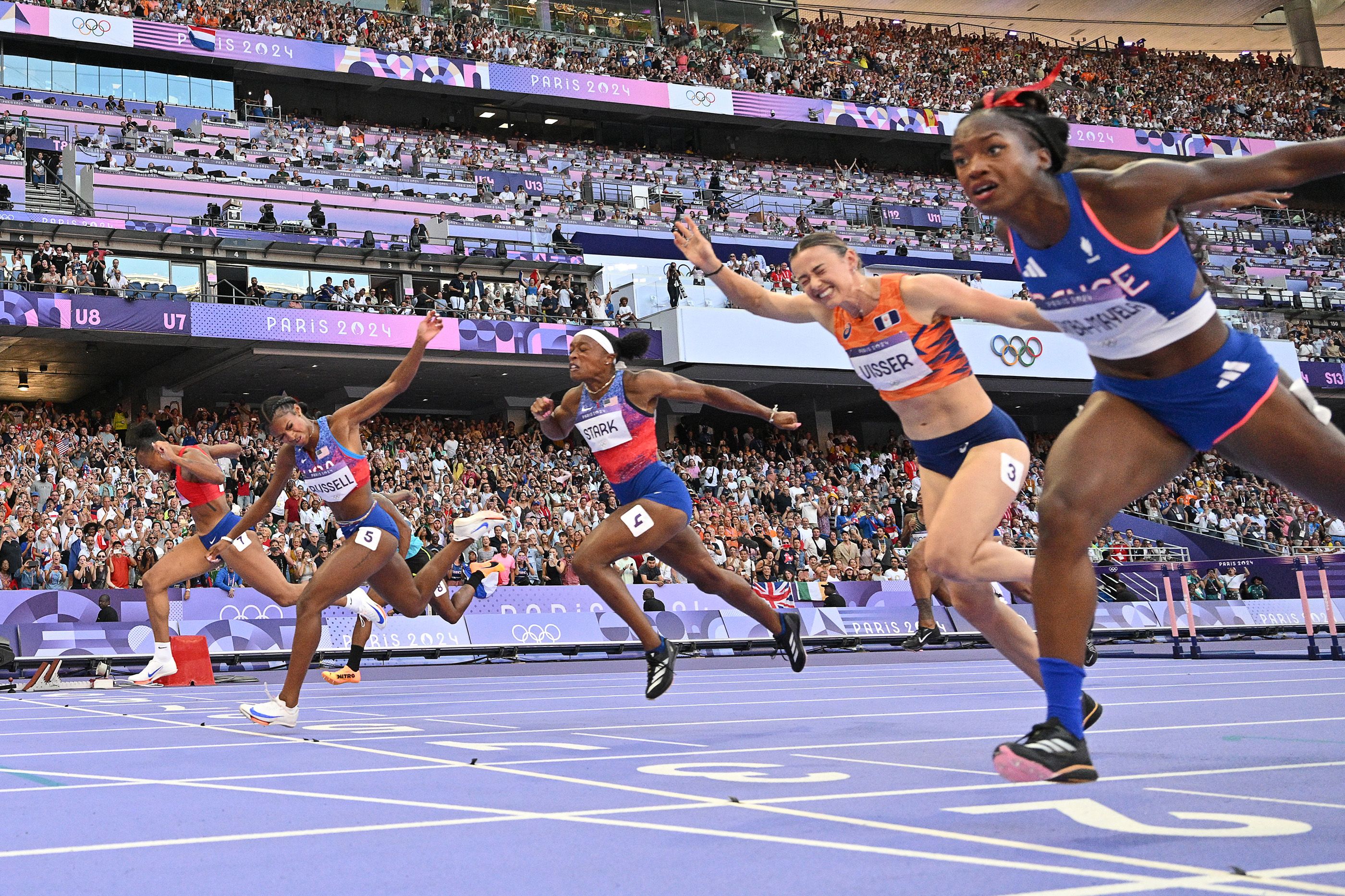 Masai Russell dips to win the Olympic 100m hurdles title in Paris