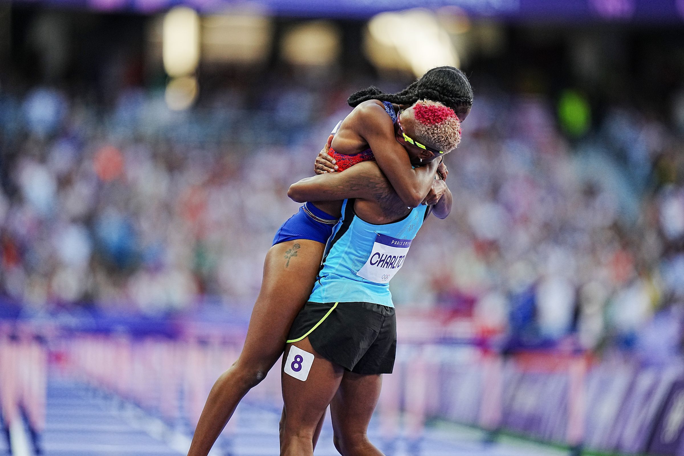 Masai Russell celebrates with her training partner Devynne Charlton in Paris