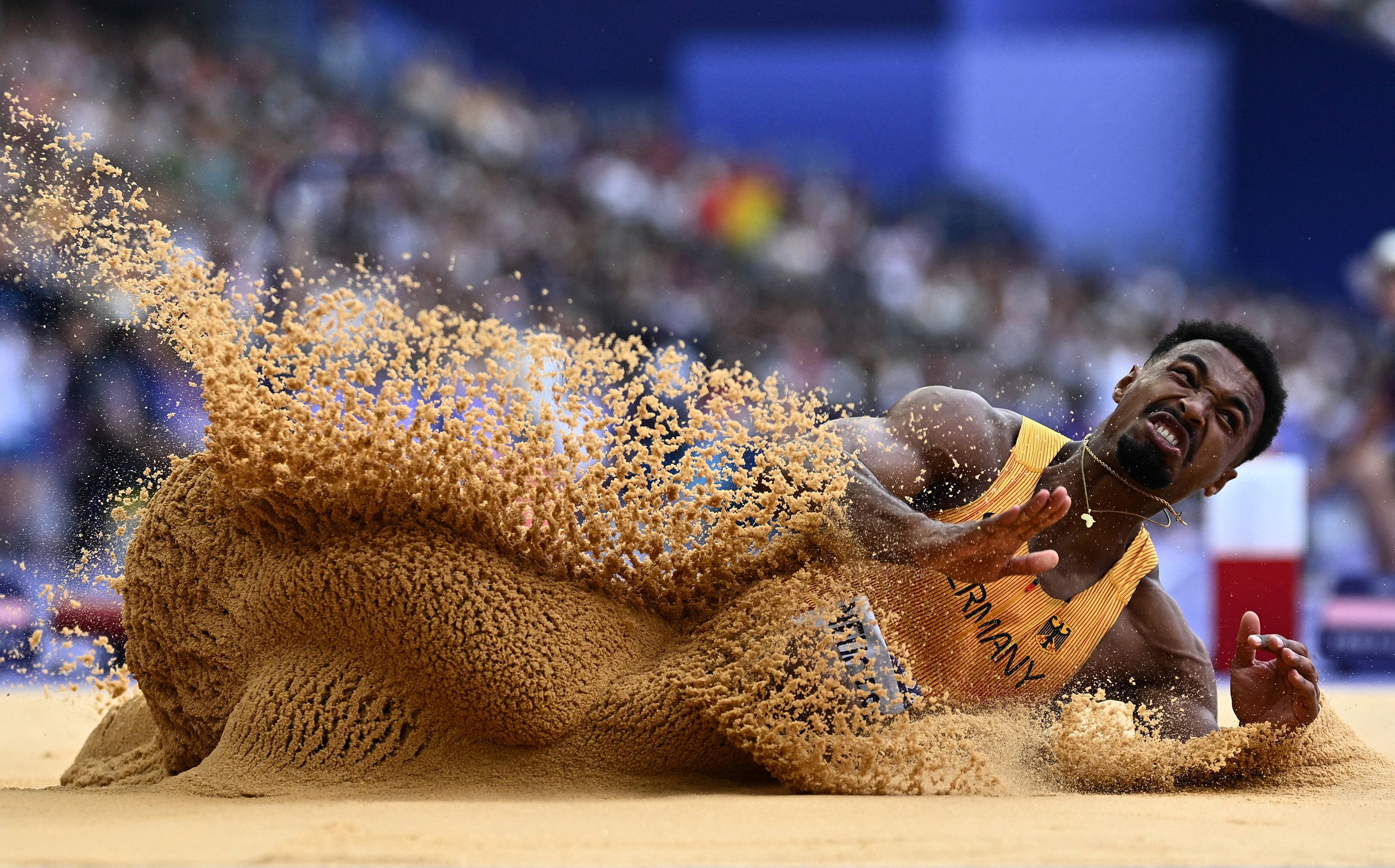 (Photo of the Year 2024 shortlist) Leo Neugebauer lands after a successful jump on way to decathlon silver in Paris