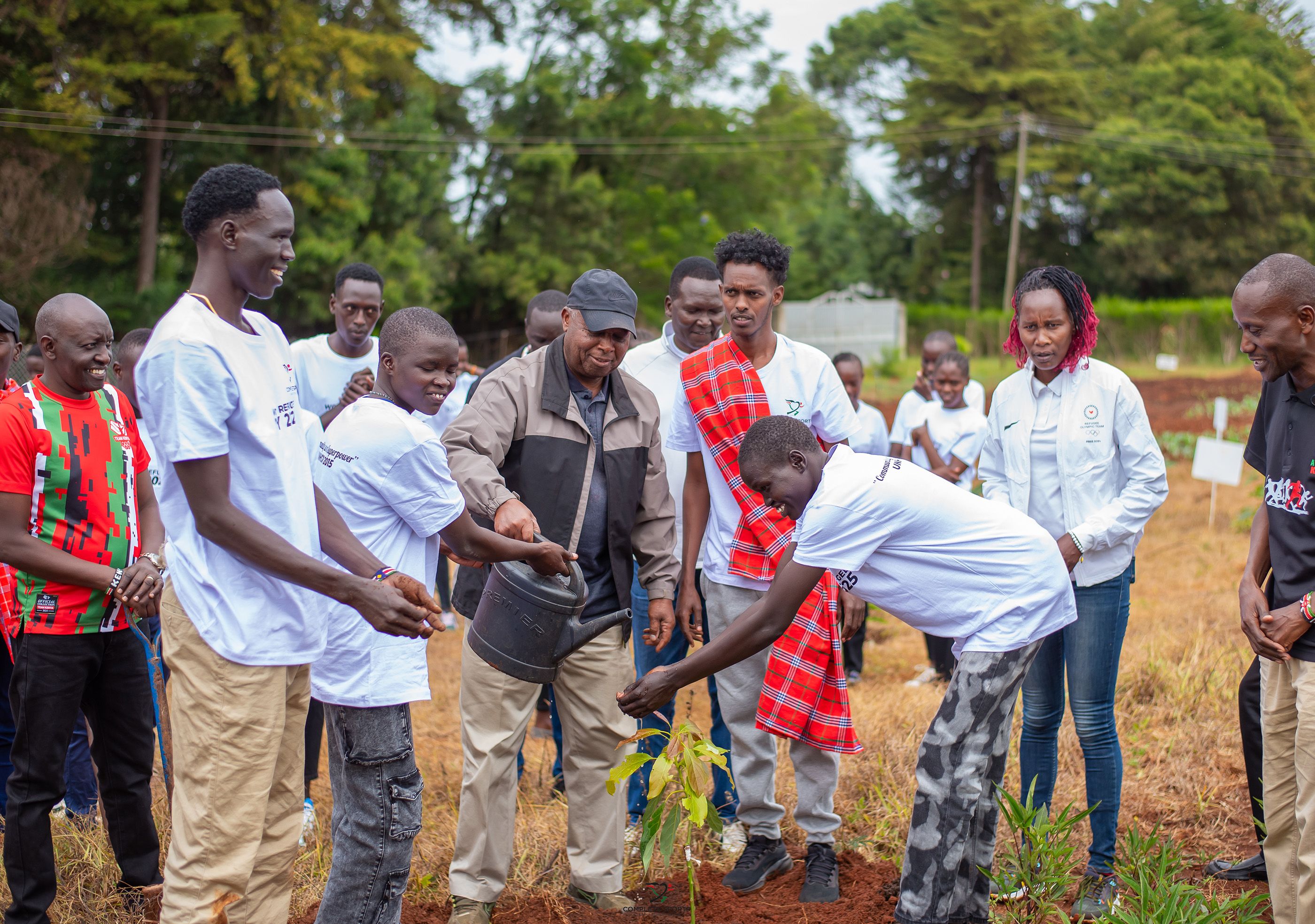 Jackson Tuwei plants a tree with refugee athletes at the Complete Sports Training Centre