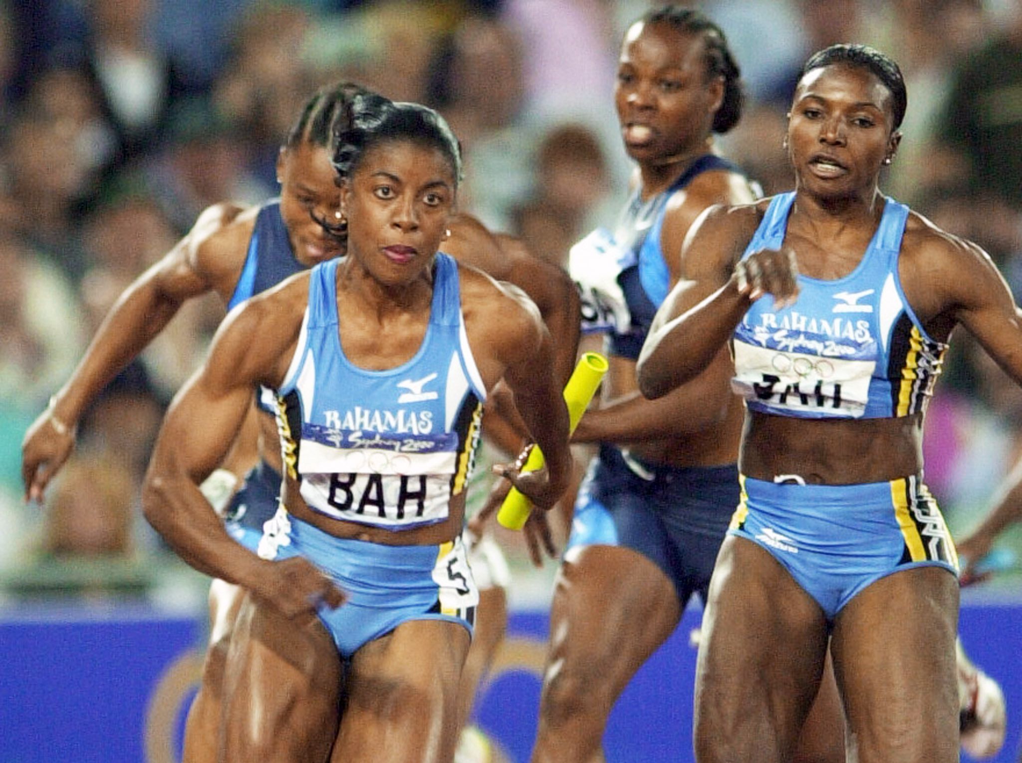 Debbie Ferguson receives the baton from Pauline Davis-Thompson during the Olympic 4x100m final in Sydney