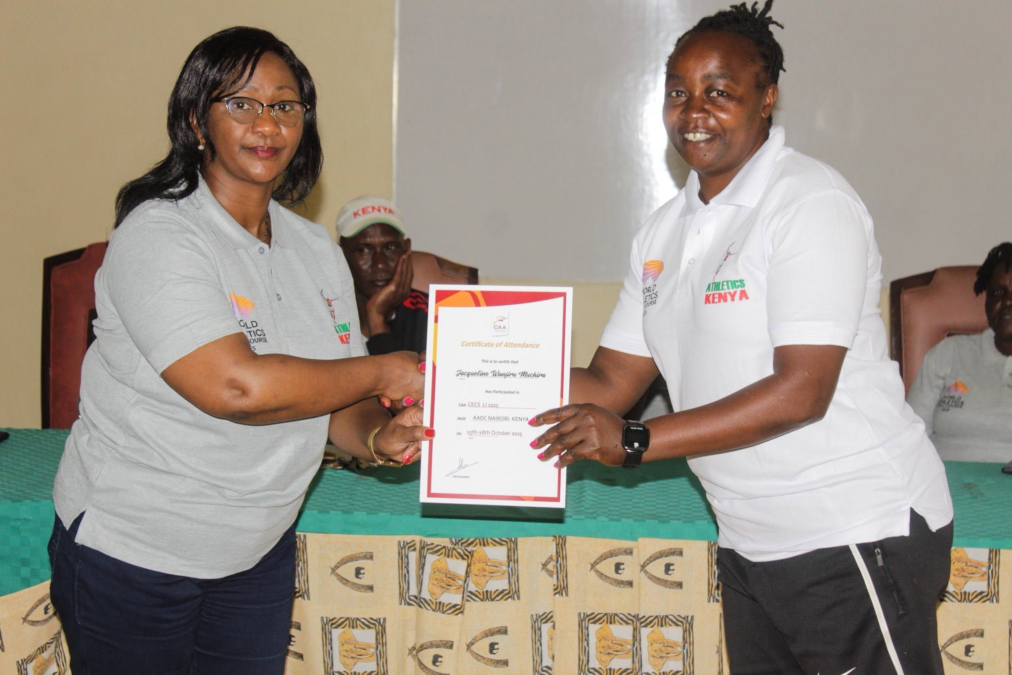 Susan Kamau presents Jacqueline Wanjiru Muchira with her coaching certificate