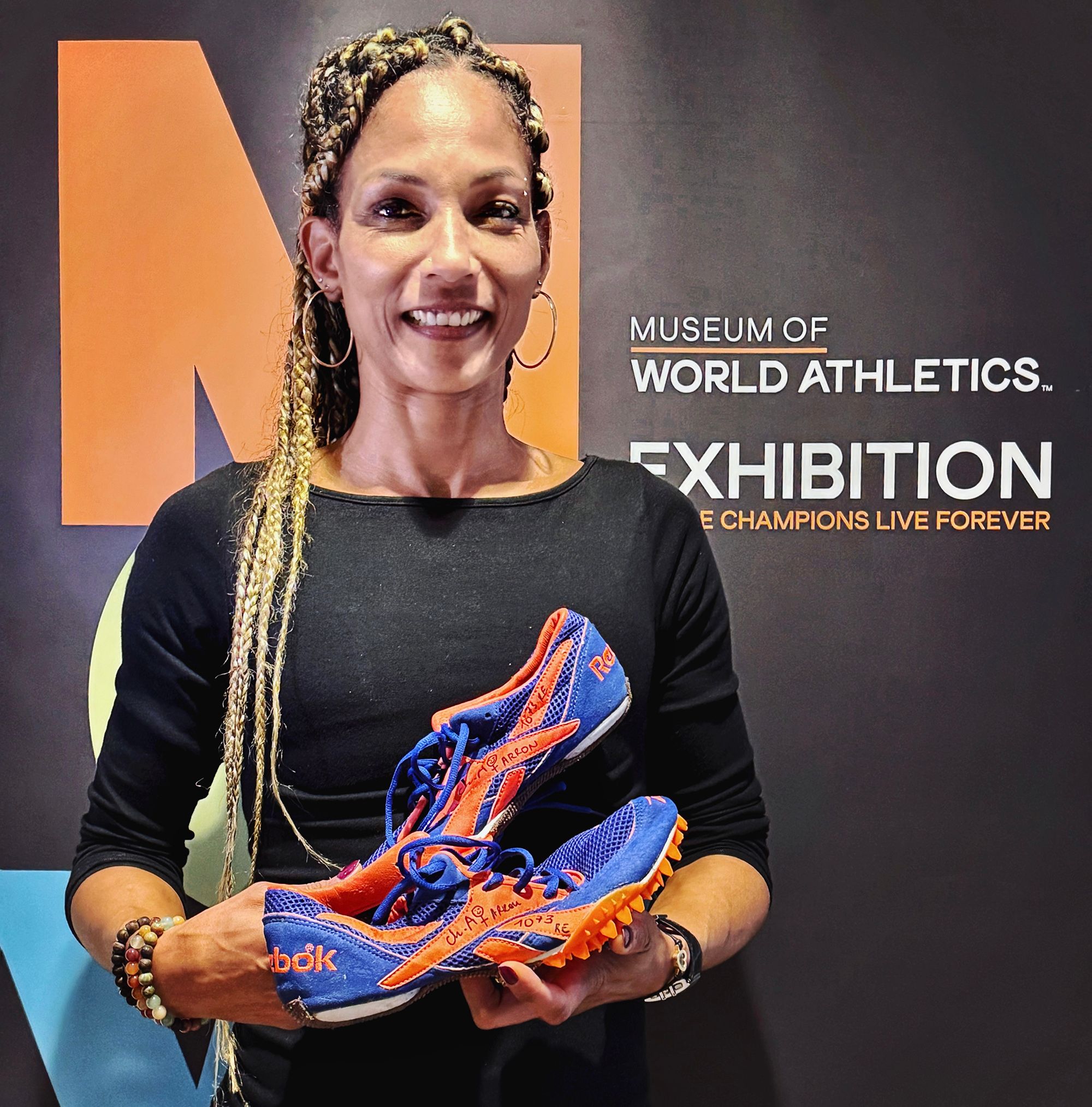 Christine Arron donates her spikes from the 1998 European Championships