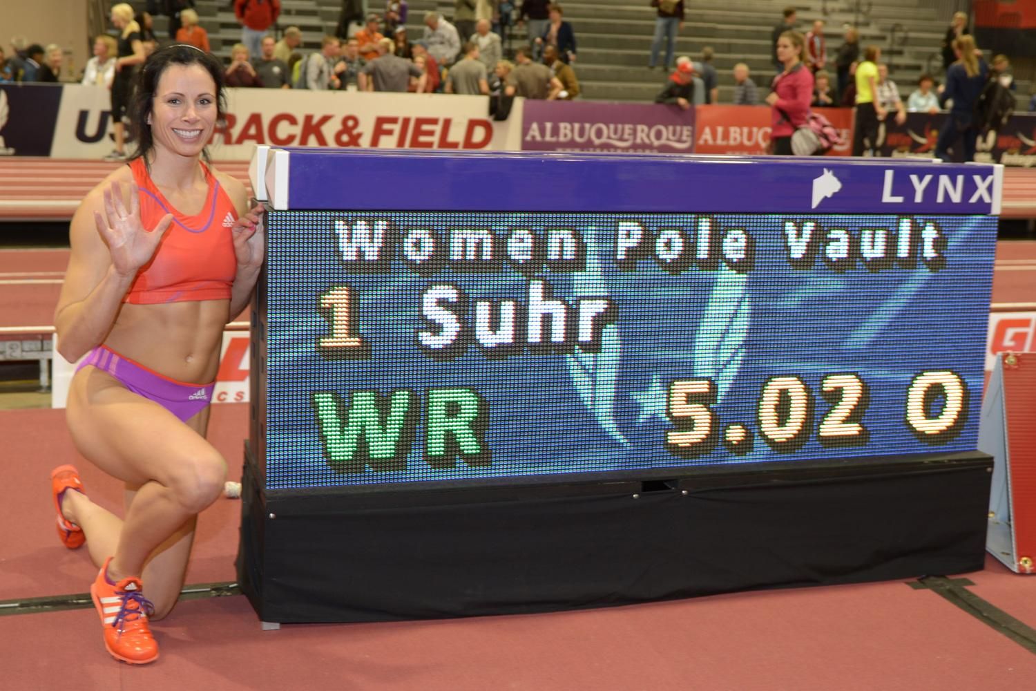 Jenn Suhr next to the scoreboard after clearing 5.02m