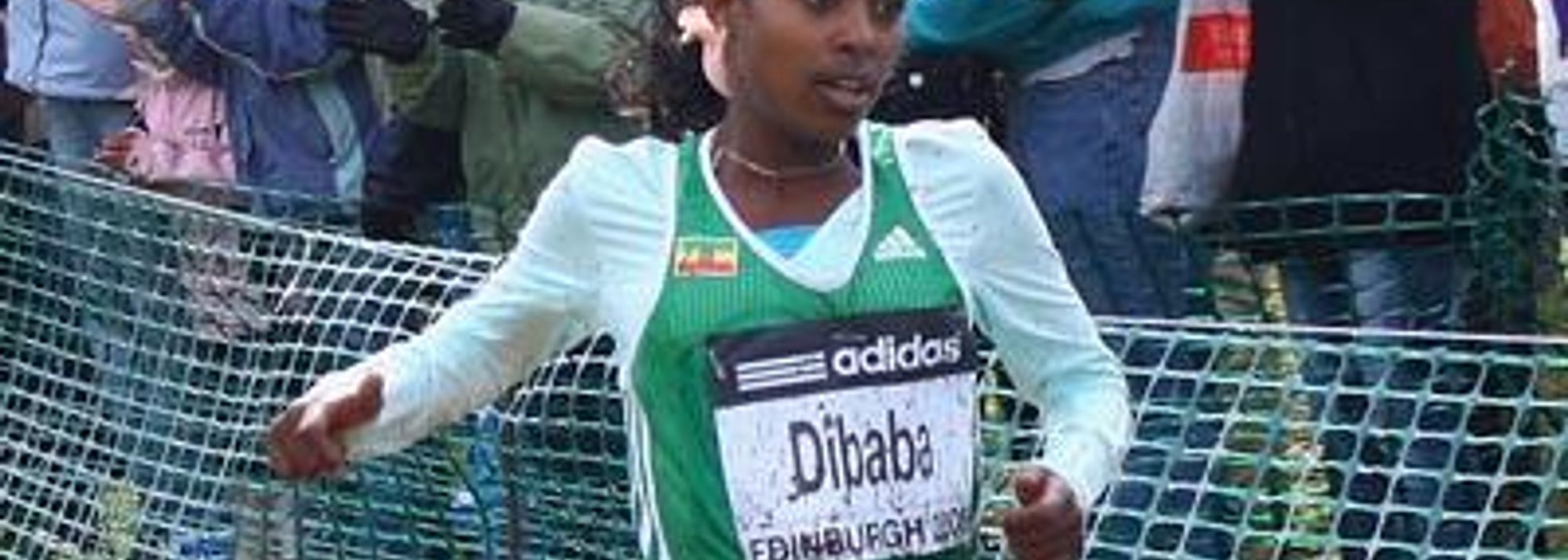 There was a familiar name on the vest and a familiar smile on the face of Genzebe Dibaba as she bounced down the final, muddy slope of the three-lap course at Edinburgh’s Holyrood Park this afternoon and sped across the line to become the 2007 IAAF World Junior Cross Country champion emulating her older sister Tirunesh who won the title in 2003.